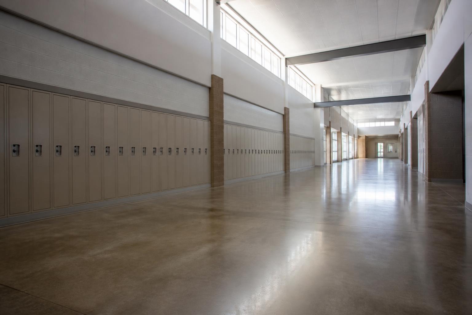 Polished concrete floor in a school corridor lined with lockers
